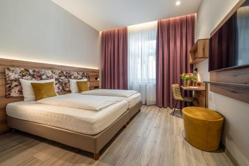 a hotel room with a bed and a television at Hotel Neue Post I self check-in in Innsbruck