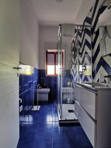 a bathroom with a glass shower and a sink at Rifugio Caretta in Montecorice