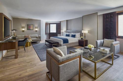 a hotel suite with a bed and a living room at Makarem Ajyad Makkah Hotel in Mecca
