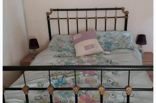 a bed with a metal headboard and pillows on it at 2-Bed Apartment - Sleeps 3 - Parking - near Albox in Albox