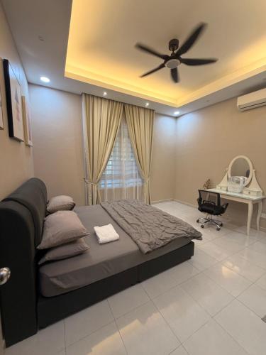 a bedroom with a bed and a ceiling fan at Casa Permai Temerloh in Temerloh