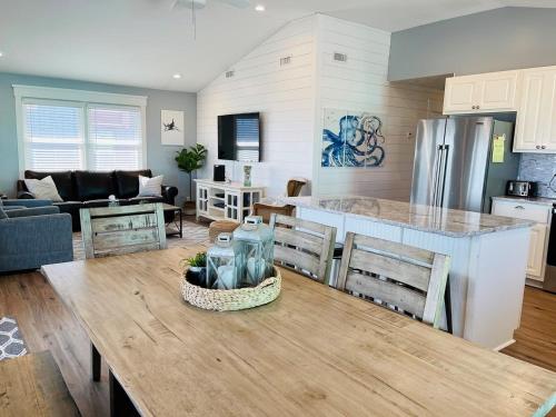 a kitchen and living room with a table and a counter at 3 4 Time in Holden Beach