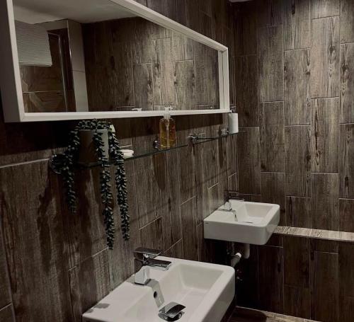 a bathroom with two sinks and a mirror at Rutland Point in Uppingham