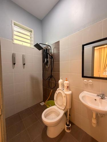 a bathroom with a toilet and a sink at Casa Permai Temerloh in Temerloh
