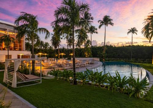 an exterior view of a resort with a pool and palm trees at Vila Gale Reserva do Paiva in Cabo de Santo Agostinho