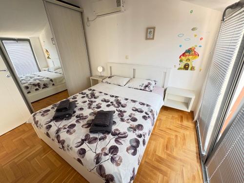 a bedroom with a bed with a floral comforter at Acacia Hills D8 in Herceg Novi in Herceg-Novi
