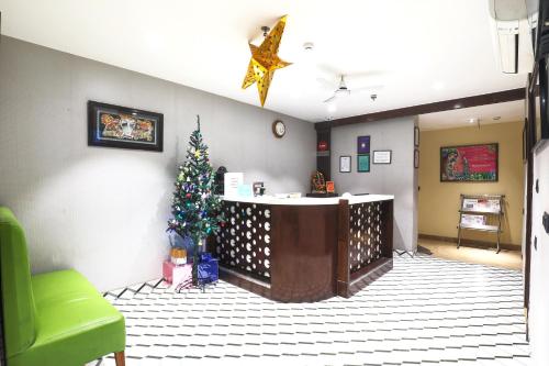a room with a christmas tree and a bar at Bluestone Nehru Place by The Cosy Hotels in New Delhi