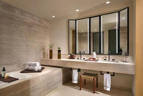 a bathroom with two sinks and a large mirror at Park Hyatt Cabo Del Sol in Cabo San Lucas