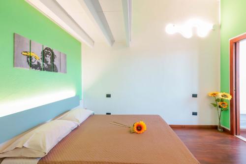 a bedroom with a bed with a flower on it at Unplug in Quartu SantʼElena