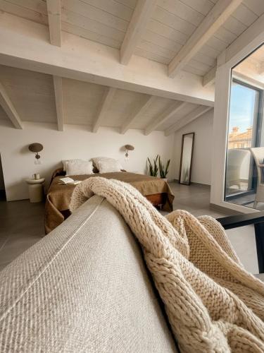 a bedroom with two beds and a large window at AGRO Sicily in Mascali
