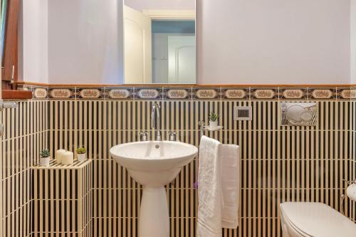 a bathroom with a sink and a toilet and a mirror at Villa Sara in San Costanzo