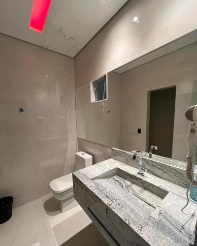 a bathroom with a sink and a toilet at Luxus Motel Caldas do Jorro in Tucano