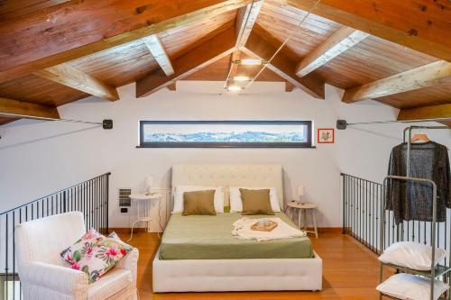 a bedroom with a bed in a room with wooden ceilings at Villa Sara in San Costanzo