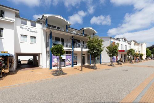 an empty street in a town with white buildings at Ferienwohnung "Ostseewind" - Bade- & Saunawelt täglich inklusive in Göhren
