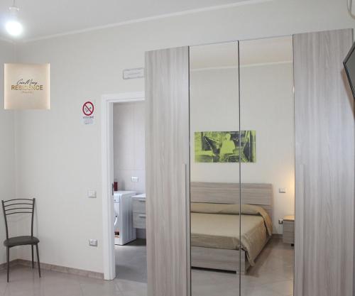 a bedroom with a bed and a glass closet at CasaMamy Residence in Pompei