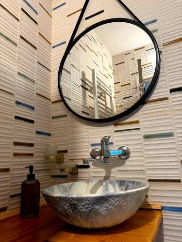 a bathroom with a sink and a mirror at Tbilisi Vake Inn in Tbilisi City