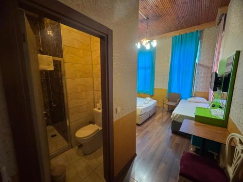 a bathroom with a bed and a shower and a toilet at Hotel Megaron in Istanbul