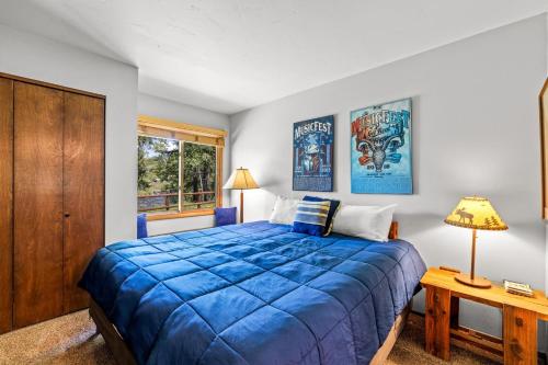 a bedroom with a blue bed and a window at Riverhouse in Clark