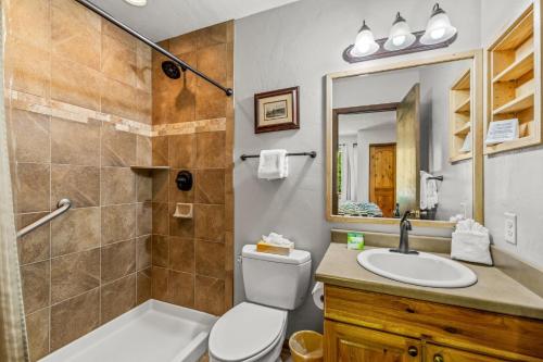 a bathroom with a toilet and a sink and a shower at Wood Duck in Clark