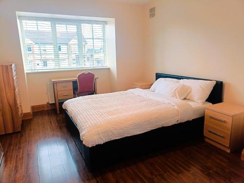 a bedroom with a large bed and a window at Ideal Guest Home in Waterford