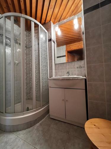a bathroom with a shower and a sink at Sziget Apartman Fonyód in Fonyód