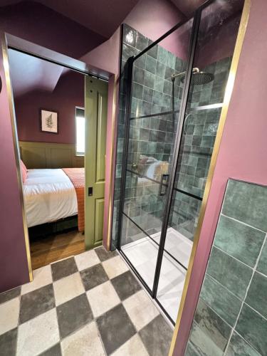 a bathroom with a glass shower in a room at The Linen Rooms in Knutsford