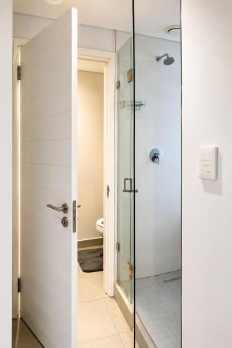 a bathroom with a shower and a toilet at Ocean Dunes Bachelor Apartments in Umhlanga