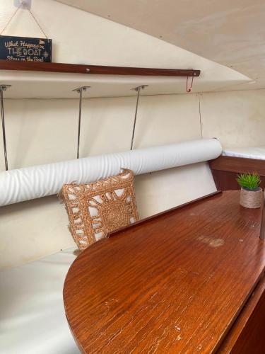 a wooden table in a boat with a bench at The Happy Sailor in Viana do Castelo