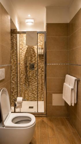 a bathroom with a toilet and a shower at Real Rooms in La Spezia