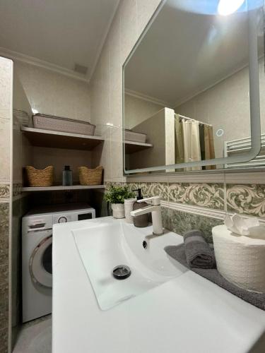 a bathroom with a white sink and a mirror at Chalet Los angeles torrevieja in Torrevieja