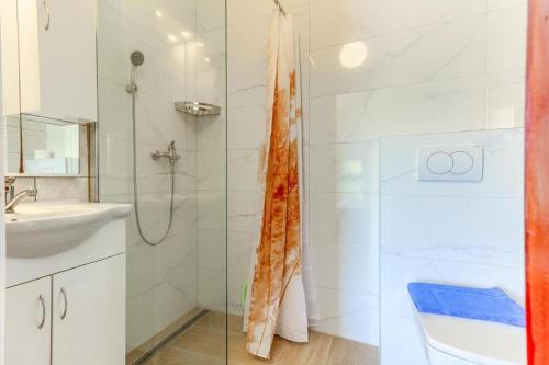a bathroom with a shower and a toilet and a sink at Villa Drago in Marina