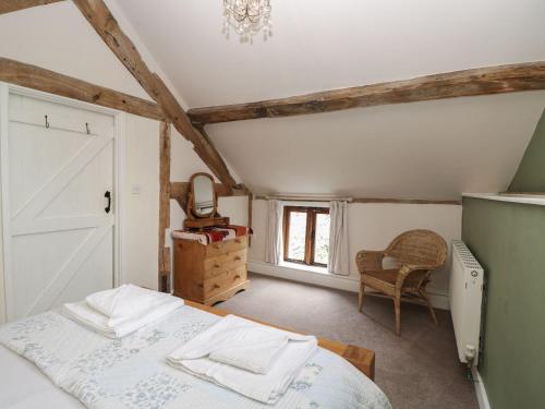 a bedroom with a bed and a dresser and a window at The Old Barn in Hereford