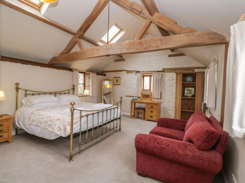 a bedroom with a bed and a couch at The Granary in Hereford