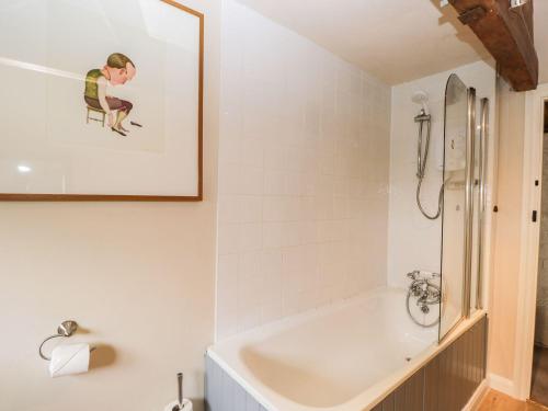 a bathroom with a sink and a bath tub at The Granary in Hereford