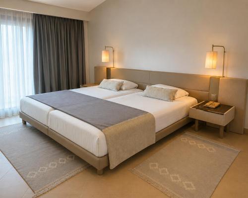 a bedroom with a large bed in a room at LAICO Hammamet hotel in Hammamet