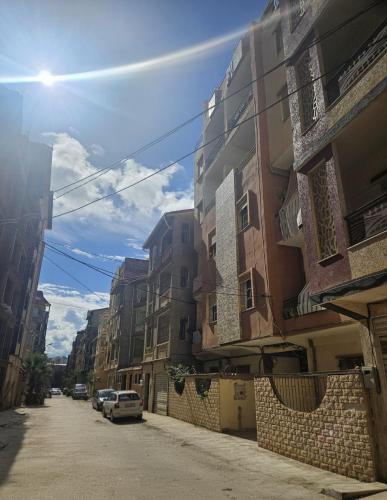 a street with buildings and cars parked on the street at Apartment - Jijel in Jijel