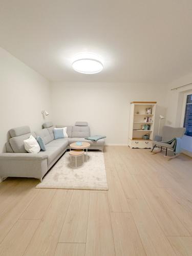 a living room with a couch and a table at Ferienwohnung Knut in Lütjenbornholt