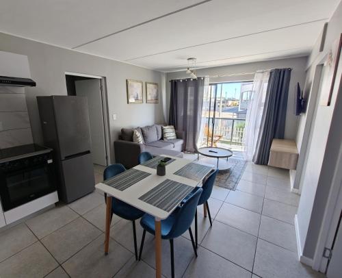 a kitchen and living room with a table and chairs at 19 on Arch in Langebaan