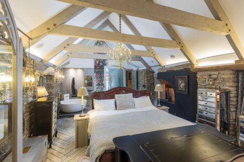 a bedroom with a large bed and a bath tub at Libertine in Breage