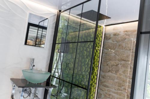 a bathroom with a glass shower and a sink at Libertine in Breage