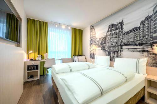 a bedroom with a large white bed and a desk at Premier Inn Hamburg City Berliner Tor in Hamburg