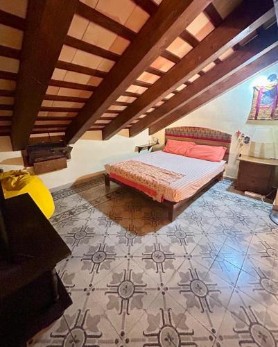 a bedroom with a bed and a tile floor at Casa Claudia Stagnone in Marsala
