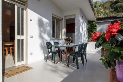 a balcony with a table and chairs on a patio at Hotel Village Eden in Capo Vaticano