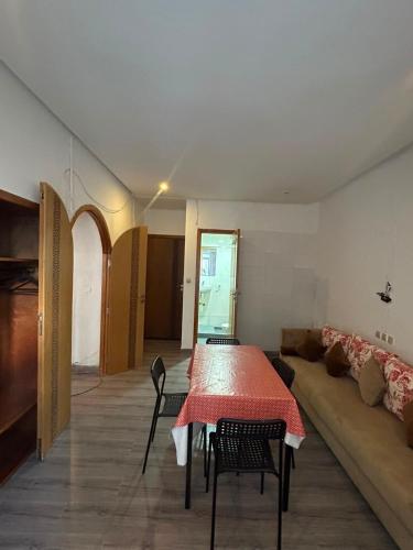 a living room with a table and a couch at Hotel Astoria Tanger in Tangier