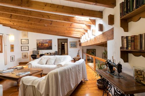 a living room with a white couch and wooden ceilings at Fabulous Rustic Villa Set On Mountain With Unique Views in Valldemossa