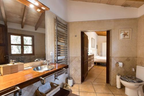 a bathroom with a sink and a toilet at Fabulous Rustic Villa Set On Mountain With Unique Views in Valldemossa