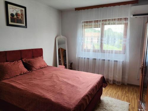 a bedroom with a large bed and a window at Ilidza Heart of the nature by Armin in Slivlje