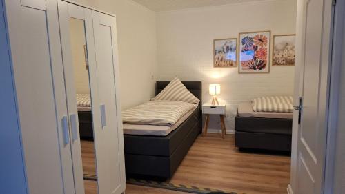 a small room with a bed and a couch at Apartment 2 Unter den Eichen in Tätendorf-Eppensen