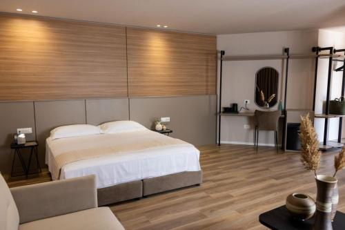 a bedroom with a large bed and a couch at KAÑ Inn in Vlorë
