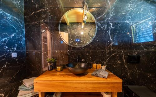 a bathroom with a wooden table with a bowl on it at RANČ Dida in Ženavlje